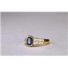 Image 1 : 18K YELLOW GOLD RING, set with an oval cut sapphire (approx. 0.90ct.) flanked by 16 channel set b...