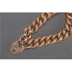 ENGLISH 9K PINK GOLD CURB LINK BRACELET, with a 9k pink gold padlock clasp and engraved decoratio...