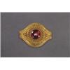Image 1 : VICTORIAN 14K YELLOW GOLD BROOCH, formed as an ellipse bezel set with a circular garnet cabochon,...