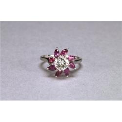 18K WHITE GOLD RING,, centering a brilliant cut diamond (approx. 0.65ct.) encircled by 8 marqui...