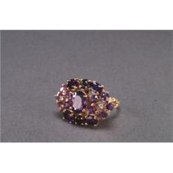 14K YELLOW GOLD, COCKTAIL RING, set with 17 various cut amethysts and, decorated with 2 small...