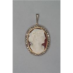 OVAL CARVED HARDSTONE CAMEO, depicting the profile of a classical maiden, in a yellow gold and si...