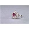 Image 1 : PLATINUM AND 18K WHITE GOLD RING, set with an oval cut ruby (approx. 0.70ct.), encircled by 28...