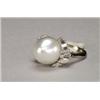 Image 1 : 18K WHITE GOLD RING, set with a cultured baroque South Sea pearl (13mm) encircled by 16 baguette...