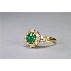ISRAELI 18K YELLOW GOLD RING, set with a circular emerald cabochon encircled by 18 brilliant cut...