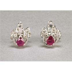 PAIR OF 18K WHITE GOLD STUD EARRINGS, each set with a pear cut ruby (approx. 0.74ct. each) in a m...
