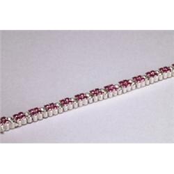 18K WHITE GOLD STRAIGHTLINE BRACELET, set with 84 full cut rubies (approx. 8.80ct. total weight)...
