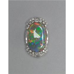BIRKS PLATINUM BROOCH, set with an oval black opal slab (27.0mm x 17.2mm x 3.75mm) encircled by 1...