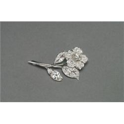 PLATINUM FILIGREE BROOCH, realistically formed as a flower and set with 2 large European cut diam...