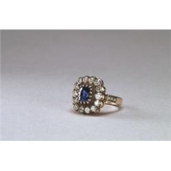 18K YELLOW GOLD AND, SILVER COCKTAIL RING, set with an oval cut sapphire (approx. 1.60ct.) enci...