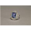 Image 1 : 18K WHITE GOLD FILIGREE COCKTAIL RING, bezel set with a fine emerald cut tanzanite (approx. 4.75c...