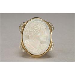 14K YELLOW GOLD RING, bezel set with an oval carved opal cameo depicting a classical, maiden in...