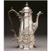 Image 1 : GEORGE II SILVER COFFEE POT, the tapering body with moulded scroll spout and wood handle repoussT...