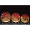 Image 1 : THREE LACQUER PLATES, each with a maki-e design on a cinnabar ground of Fukujin, one of Hotei, th...