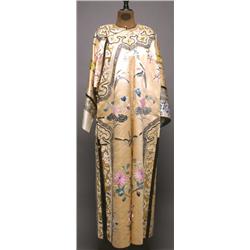 AN EMBROIDERED SILK INFORMAL ROBE, the gold ground worked with butterflies and lotus, the flower...