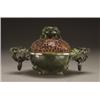 Image 1 : A FINE SERPENTINE INCENSE BURNER, the bowl with everted rim, worked with flowers, raised on three...