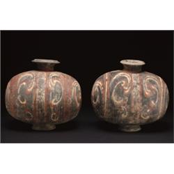 A PAIR OF GREY PAINTED POTTERY COCOON VESSELS, painted in red and white with bold arabesques on a...