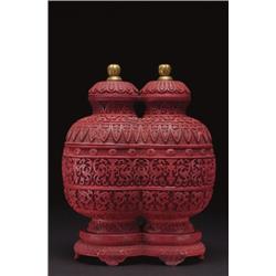 A FINE CINNABAR LACQUER STACKING BOX, fashioned as conjoined baluster jars, horizontally divided...