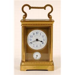 A Brass Carriage Clock, with alarm, the enamel dial with Arabic numerals, signed "Harrods Ltd", with