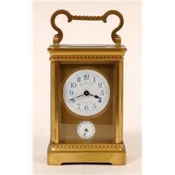 A Brass Carriage Clock, with alarm, the enamel dial with Arabic numerals, signed "Harrods Ltd", with