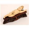 Image 1 : A 19th Century Japanese Carved Ivory Medicine Lady, lying on her back, on a pierced hardwood stand (