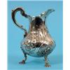 Image 1 : An 18th Century Style Silver Jug, decorated in relief with flowers and a vacant cartouche, on shell