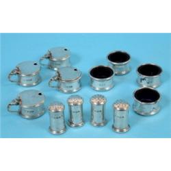 A Silver Condiment Set, of plain cylindrical form, comprising four pepper pots, four salts, and four