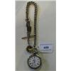Image 1 : An Open Face Pocket Watch, with enamel dial and Roman numerals, in a white metal case, and silver wa