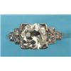 Image 1 : A Platinum and Diamond Ring, the large central diamond flanked by three smaller diamonds on stepped