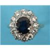 Image 1 : An 18ct Gold Diamond and Sapphire Ring, the sapphire within a surround of twelve diamonds See colou