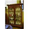 Image 1 : A Mahogany Bookcase, the moulded cornice above a pair of glazed doors enclosing shelves, on a later