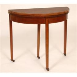 An Edwardian Mahogany Card Table, the demi-lune fold over top on square tapering legs, 77 cm See il