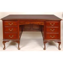 A Mahogany Desk, the central shaped frieze drawer flanked by six short drawers, on cabriole legs, 1