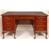 Image 1 : A Mahogany Desk, the central shaped frieze drawer flanked by six short drawers, on cabriole legs, 1