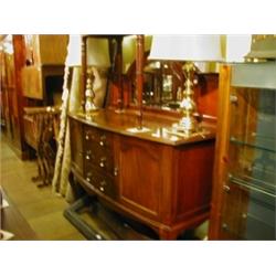 An Edwardian Bow Front Sideboard, the mirror back above three central drawers flanked by a pair of c