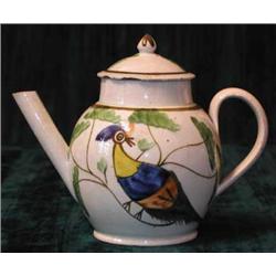 An 18th century pearlware lidded teapot of small size, the painted decoration depicting colourfu...