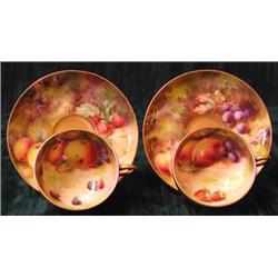 A Royal Worcester cup and saucer, the cup interior painted with peaches, grapes and strawberries...