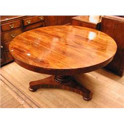 A 19th century rosewood tilt top breakfast table with circular top on pedestal base...