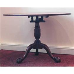 A George III mahogany snap top table with circular top, birdcage action and well carved tripod b...