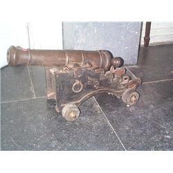 A REGENCY SIGNAL CANNON,, EARLY 19th CENTURY, 57cm barrel, on an iron and, timber trunnion with...