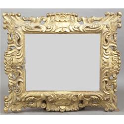 A FLORENTINE CARVED GILTWOOD PICTURE FRAME, FIRST HALF 19th CENTURY, with pierced scroll frame, now.