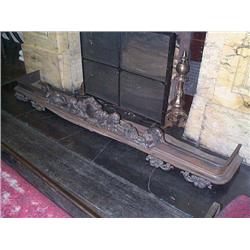 A WILLIAM IV CAST-IRON FENDER, circa 1835,, of rounded rectangular form with foliate surrounded sh..