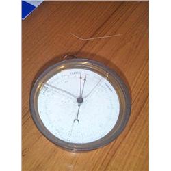 A VICTORIAN ANEROID BAROMETER IN A MACHINED GLASS CASE, 19th CENTURY, 12.5cms diameter., e600/80...