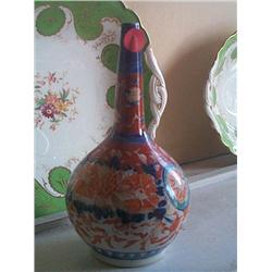 AN ORIENTAL TALL NECK FLASK, circa 1900,, decorated in imari colours, 31cms high., e30/50...