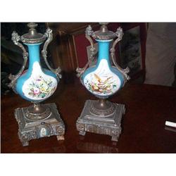 A PAIR OF SMALL METAL AND PORCELAIN URNS, circa 1900, 25cms high. (2), e30/50...