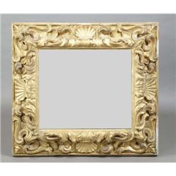 A FLORENTINE CARVED GILTWOOD PICTURE FRAME, PROBABLY LATE 17th/ EARLY 18th CENTURY and enlarged in s