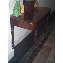 A REGENCY EBONY-INLAID MAHOGANY, TEA TABLE, circa 1810, the rounded rectangular, swivel-action t...