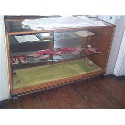 AN ART DECO OAK AND EBONISED DISPLAY CABINET, circa 1930, with glazed top and sides, the sliding doo