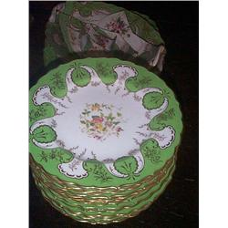 A COALPORT PART DESSERT SERVICE,, EARLY 20th CENTURY, gilded, with apple green borders the centres..