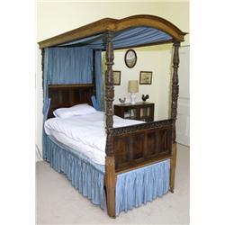 A LATE VICTORIAN OAK SINGLE FOUR POST BED, SECOND HALF 19th CENTURY,, the arched cornice hung with..